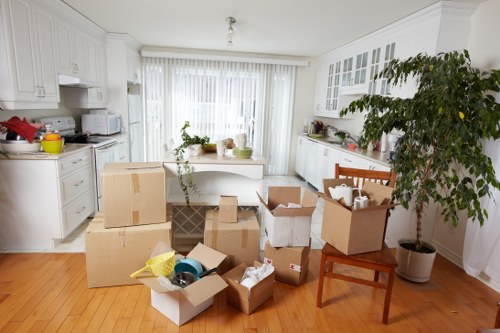 Professional movers handling furniture in a Highams Park property