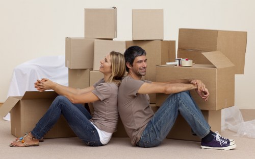 Professional movers loading items for transport in Highams Park