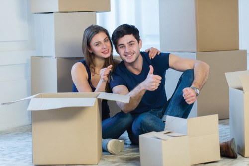 Trained movers handling boxes with care in Highams Park
