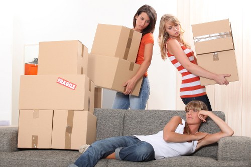 Furniture being carried through a flat move in Highams Park